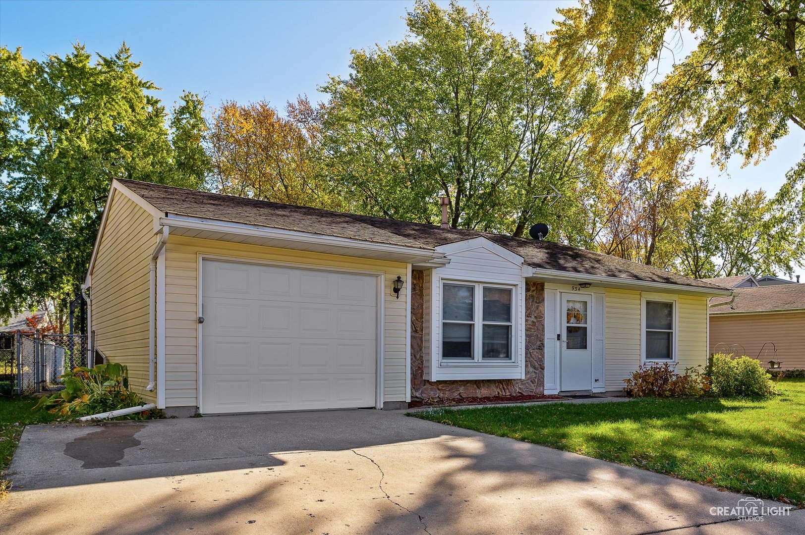 a front view of a house with a garden and yard