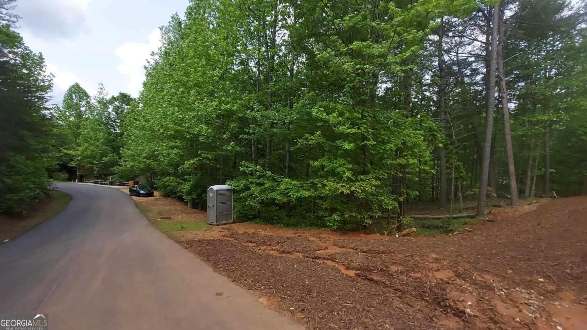 a view of a street with trees in the background