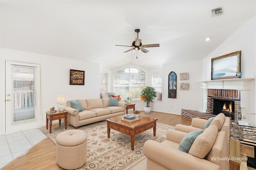 a living room with furniture a fireplace and a flat screen tv