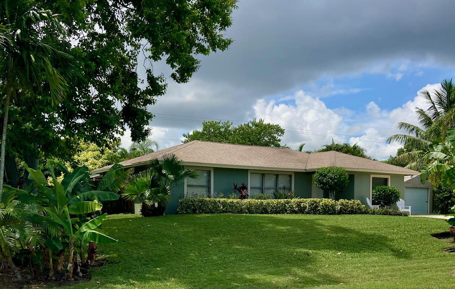 a front view of a house with a garden