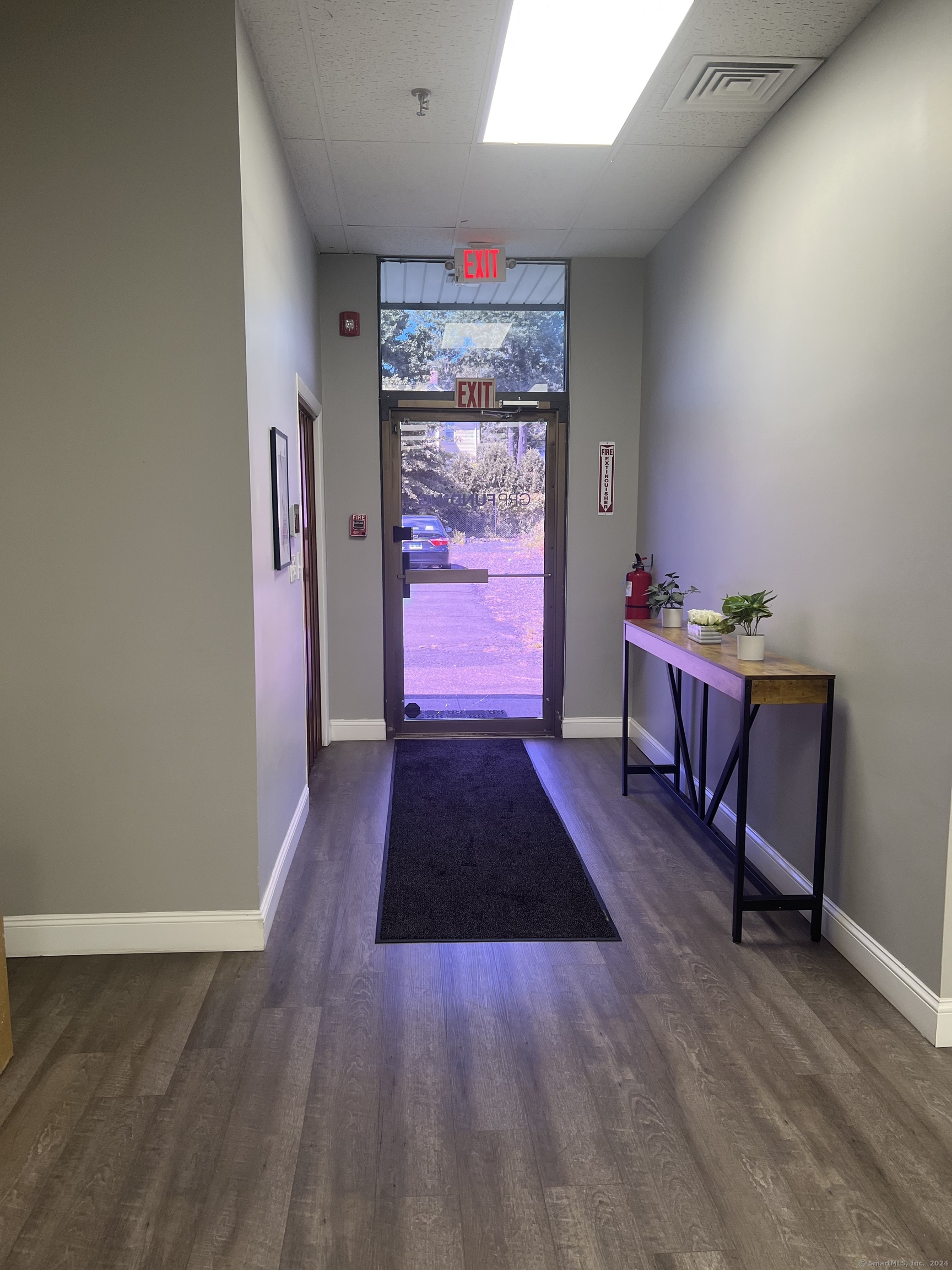 a room with wooden floor and furniture