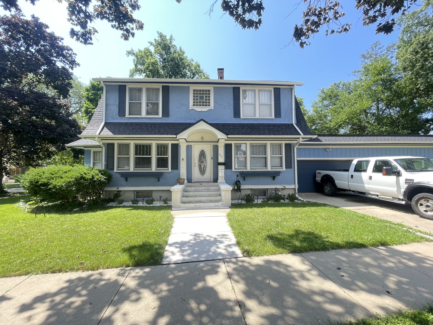 a front view of a house with garden and porch