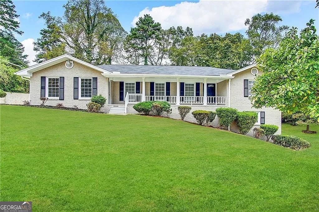 a front view of house with yard and green space