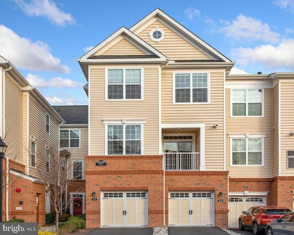 a front view of a residential apartment building with a yard