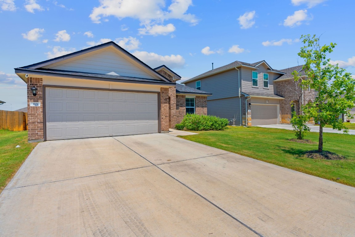 a front view of house with garage and yard