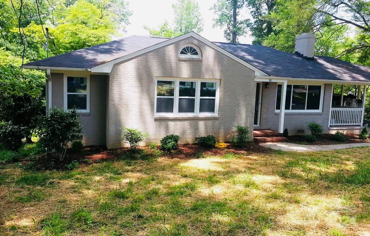 a front view of a house with yard and green space