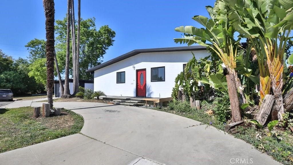 a view of a house with palm trees