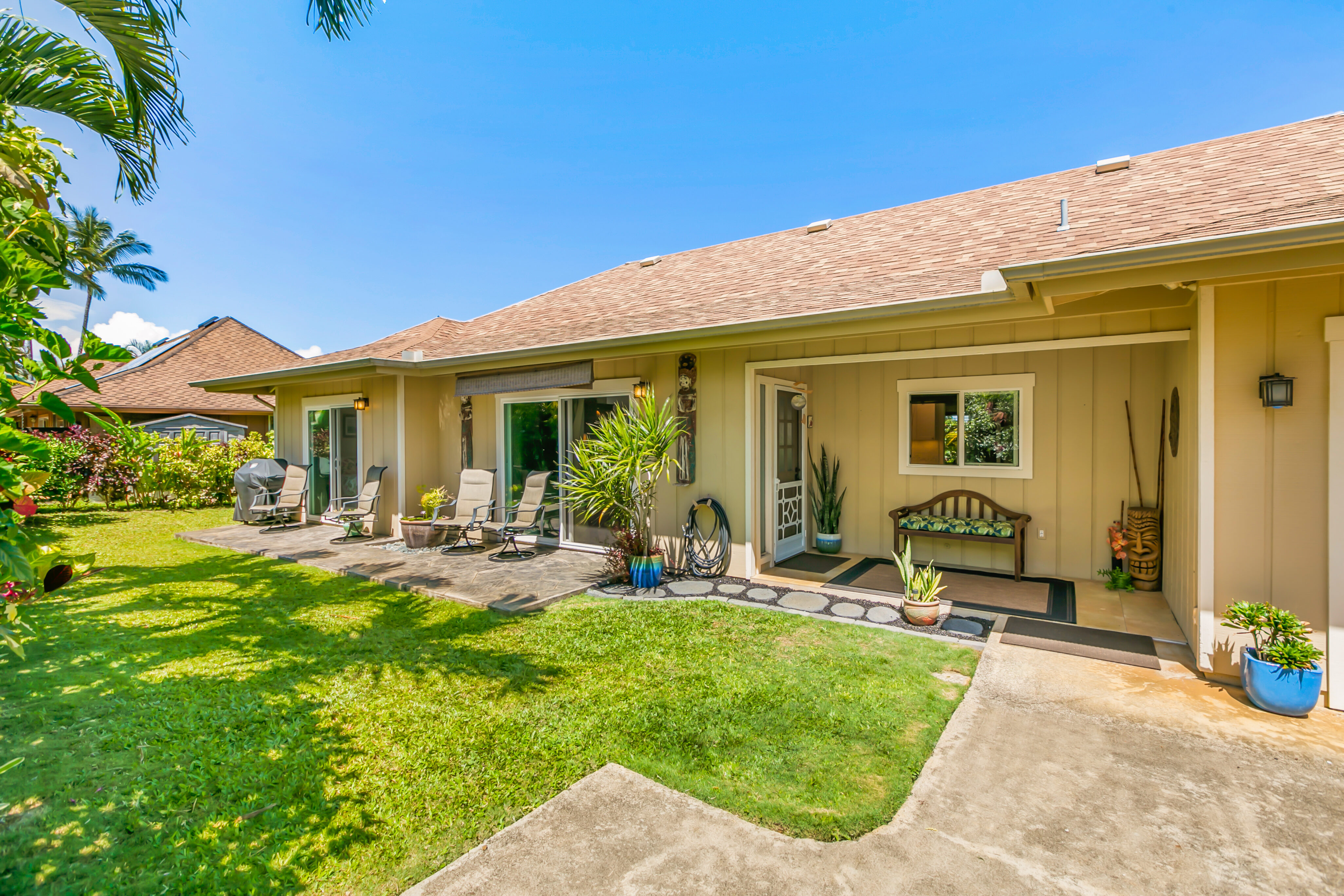 a view of a house with backyard porch and sitting area