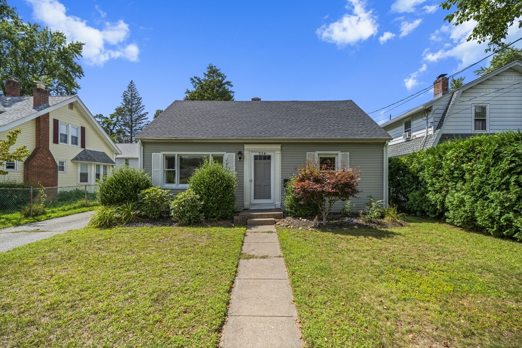 a front view of a house with garden