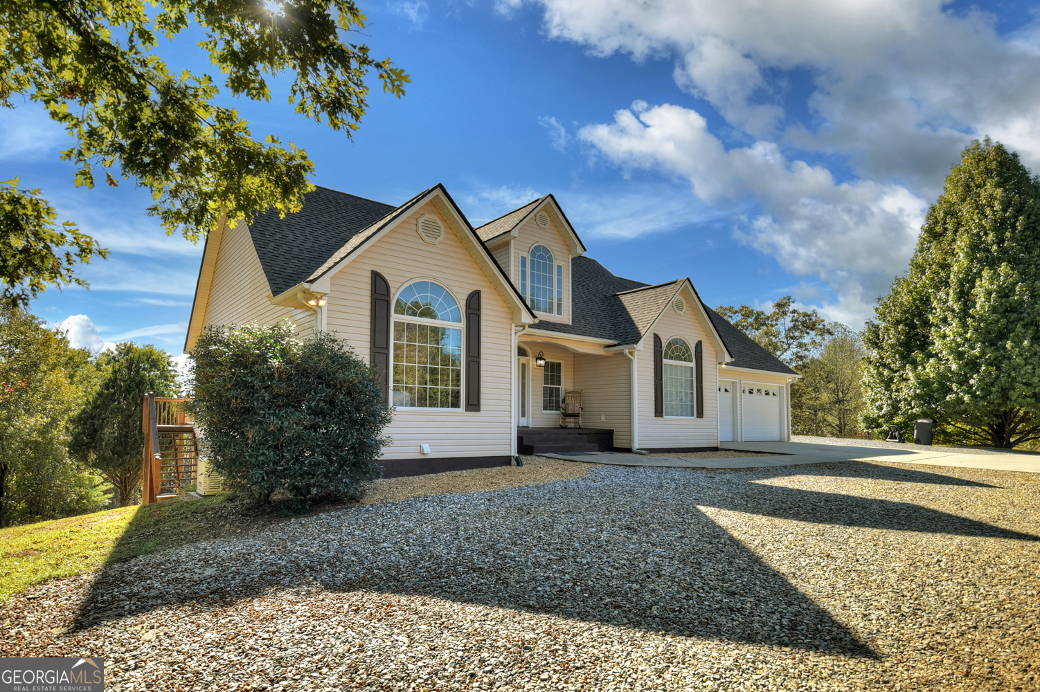 a front view of a house with a garden