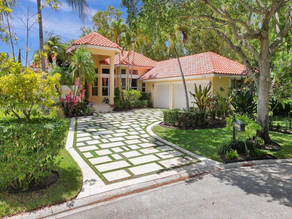 a view of a house with backyard and sitting area