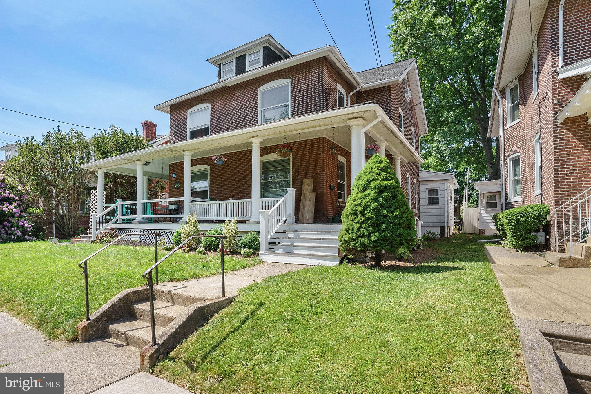 a view of house with a yard and plants