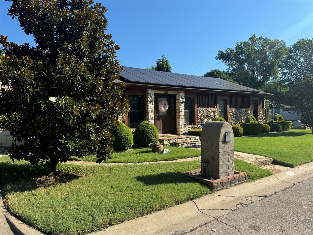 a front view of a house with garden