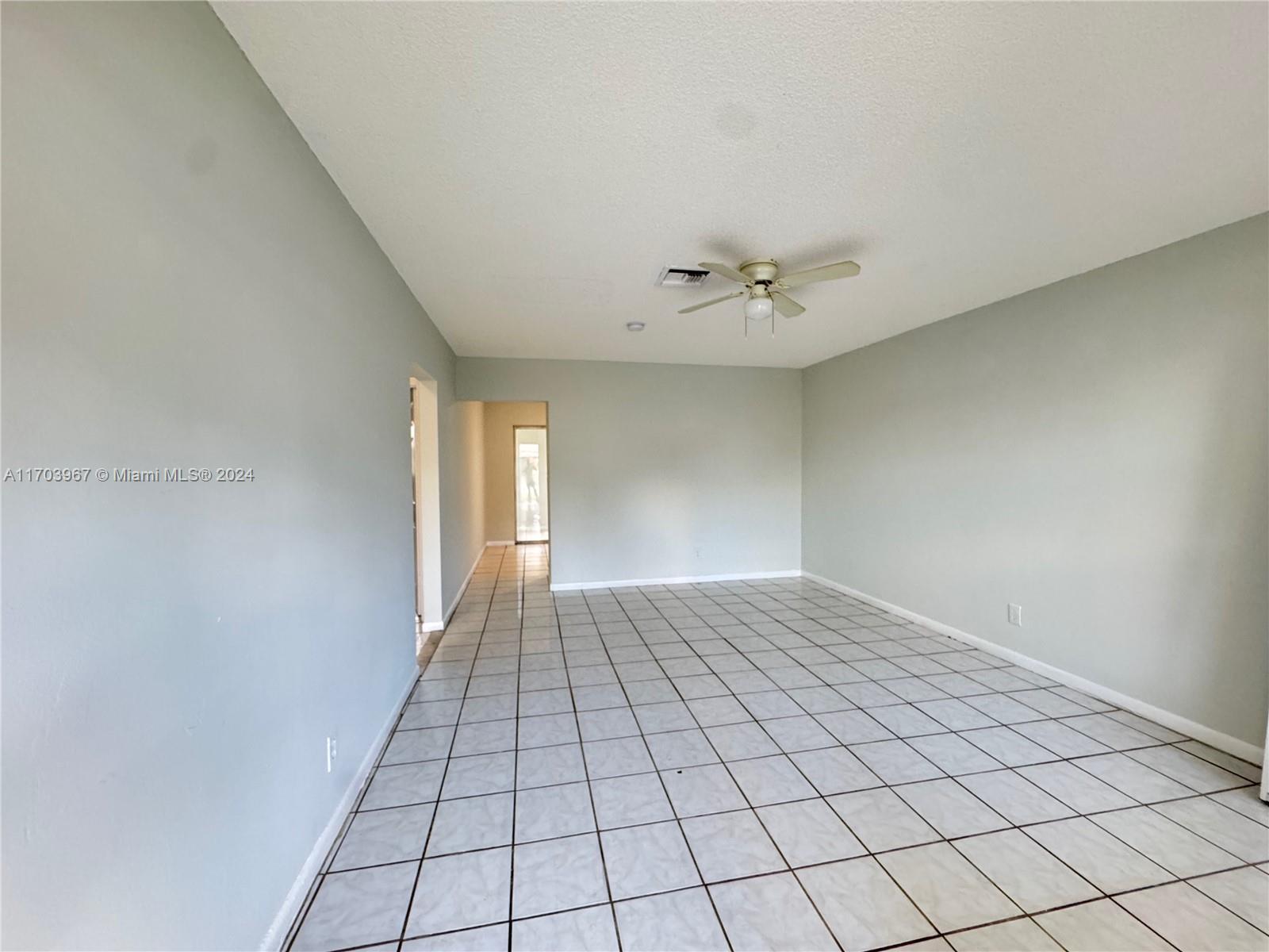 a view of an empty room and a window