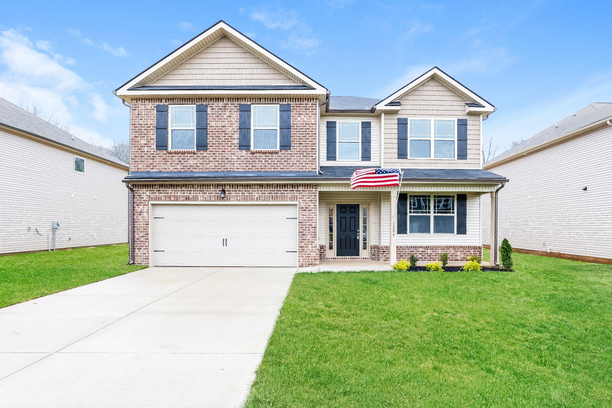 a front view of a house with a yard and garage