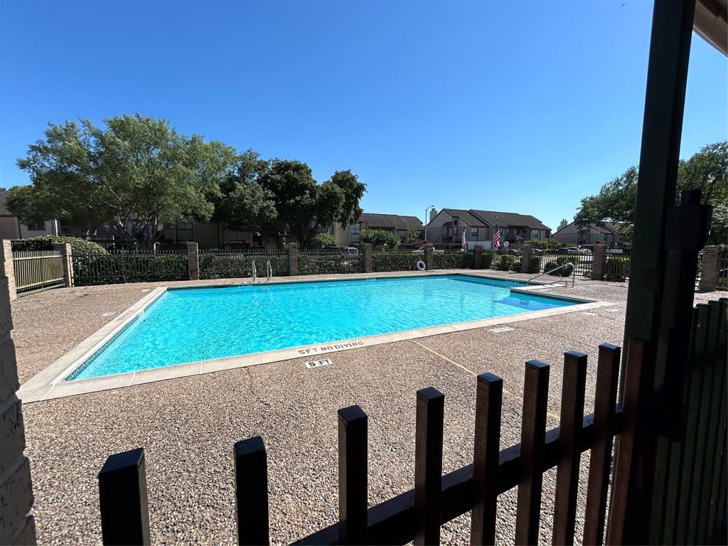 a view of a swimming pool with a yard