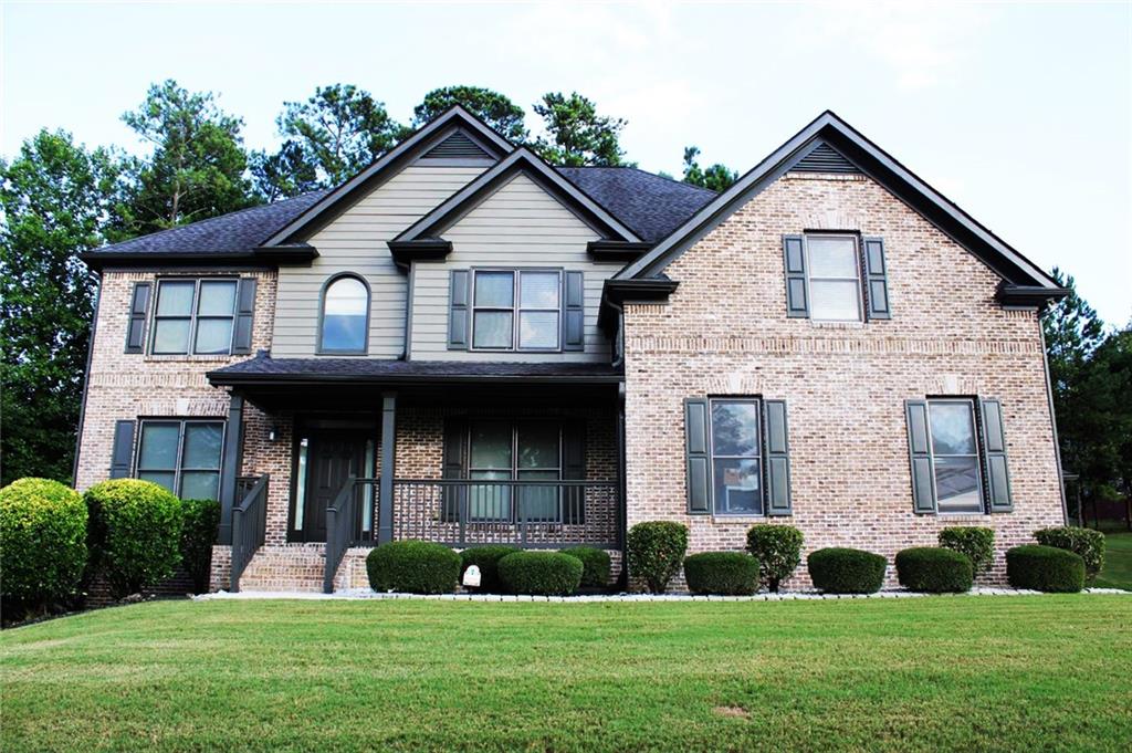 a front view of a house with a yard