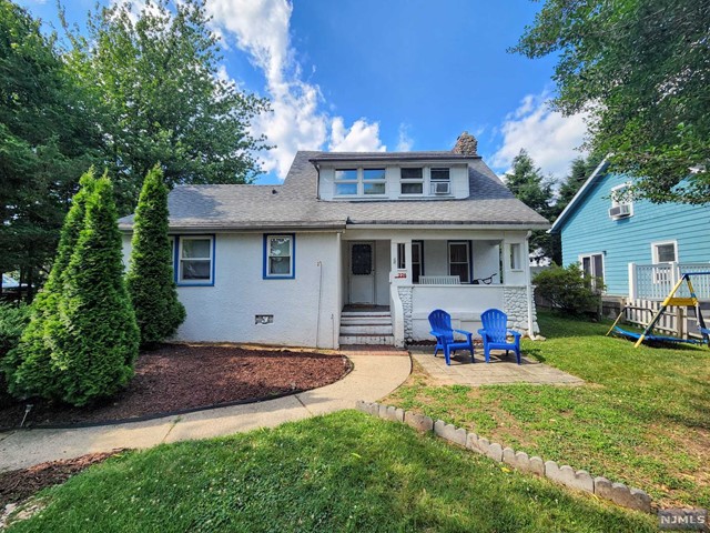 a view of a house with a yard porch and sitting area