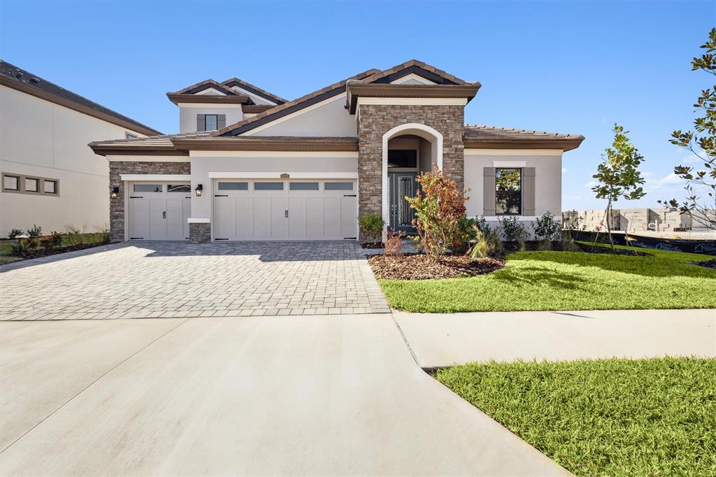 a front view of a house with a yard and garage