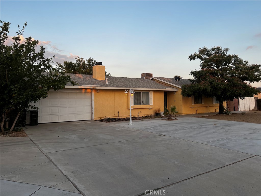 a view of a house with a yard and garage