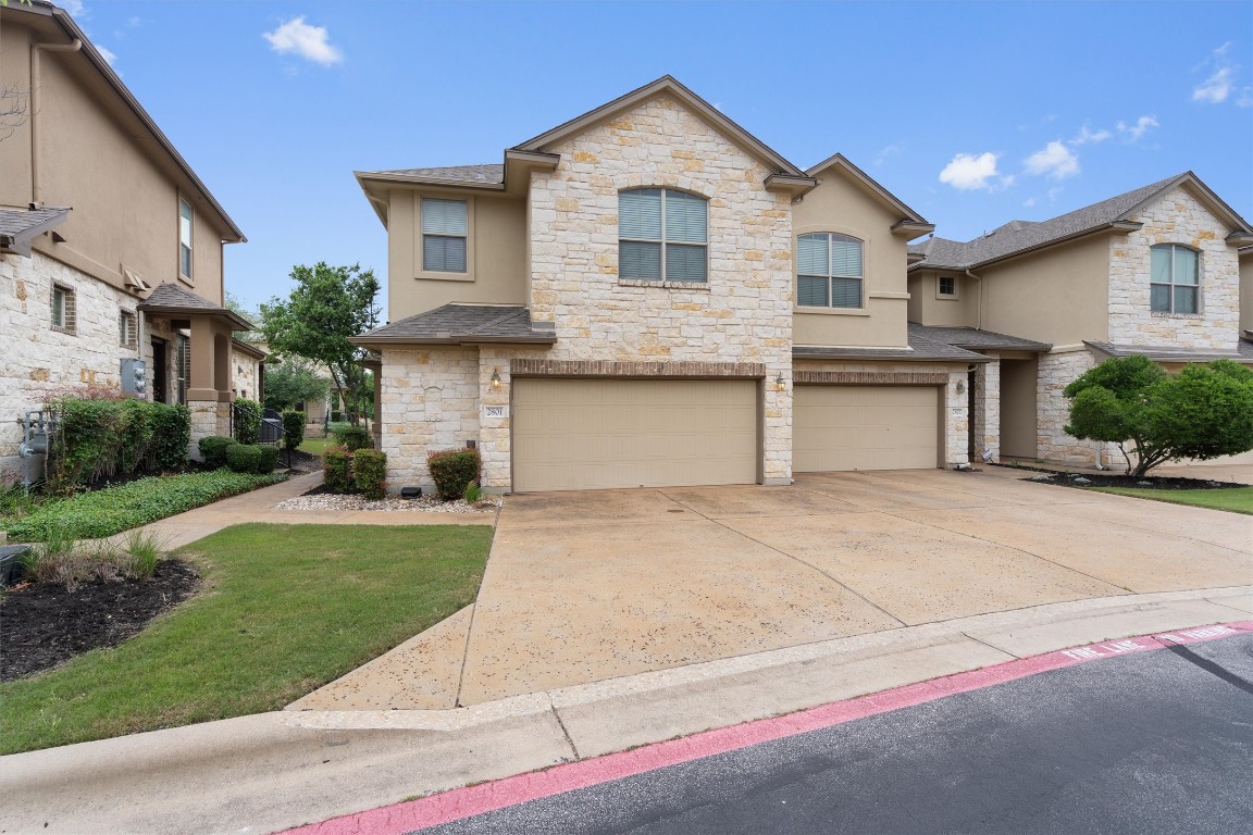 a front view of a house with a yard and garage