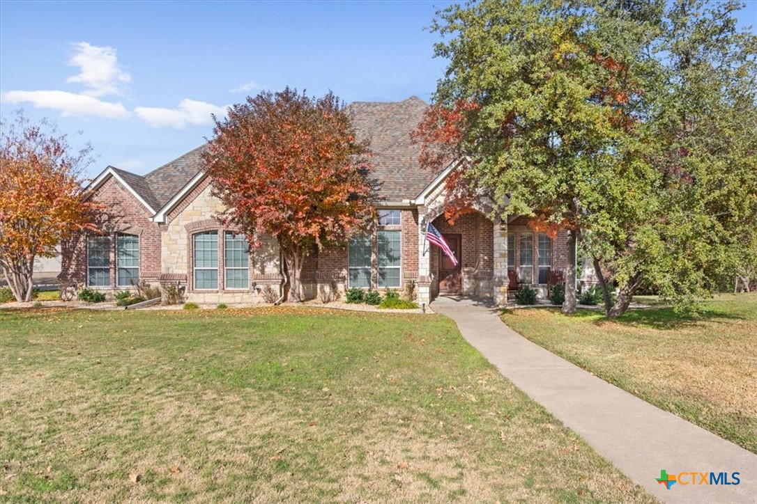 a view of a house with a yard and garage