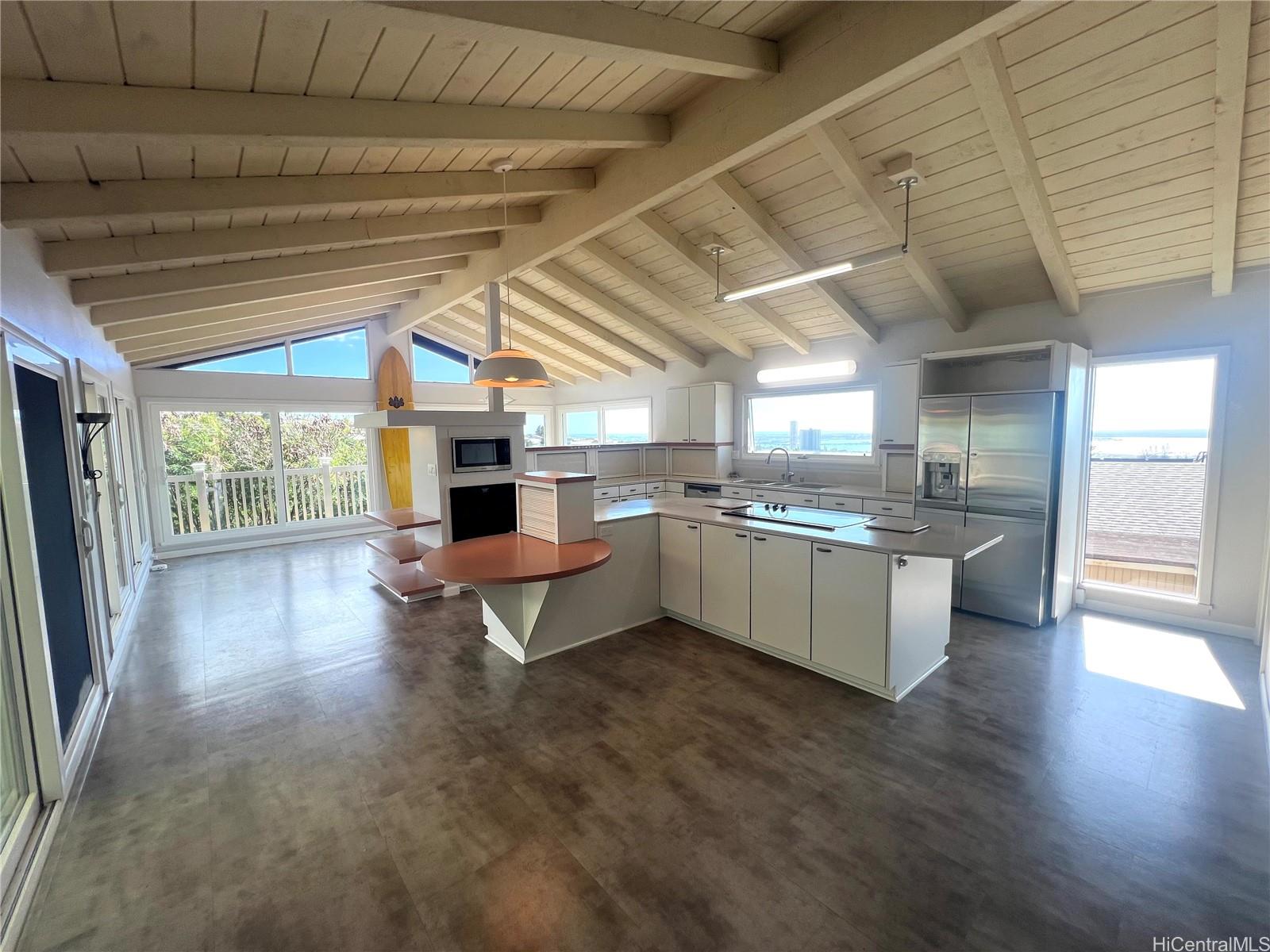 a large white kitchen with a large window