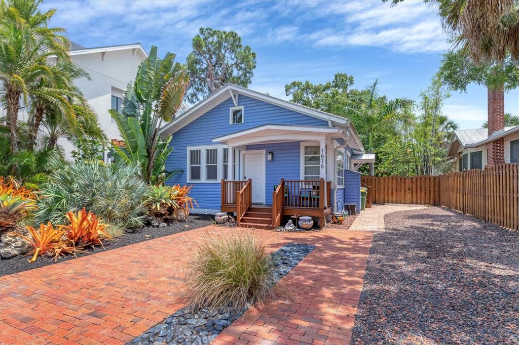 a view of a house with backyard sitting area and garden