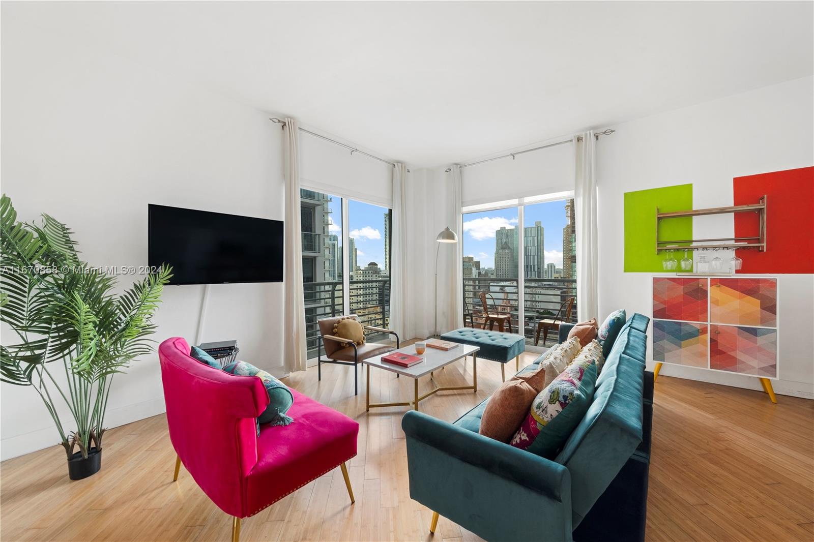 a living room with furniture a flat screen tv and a floor to ceiling window