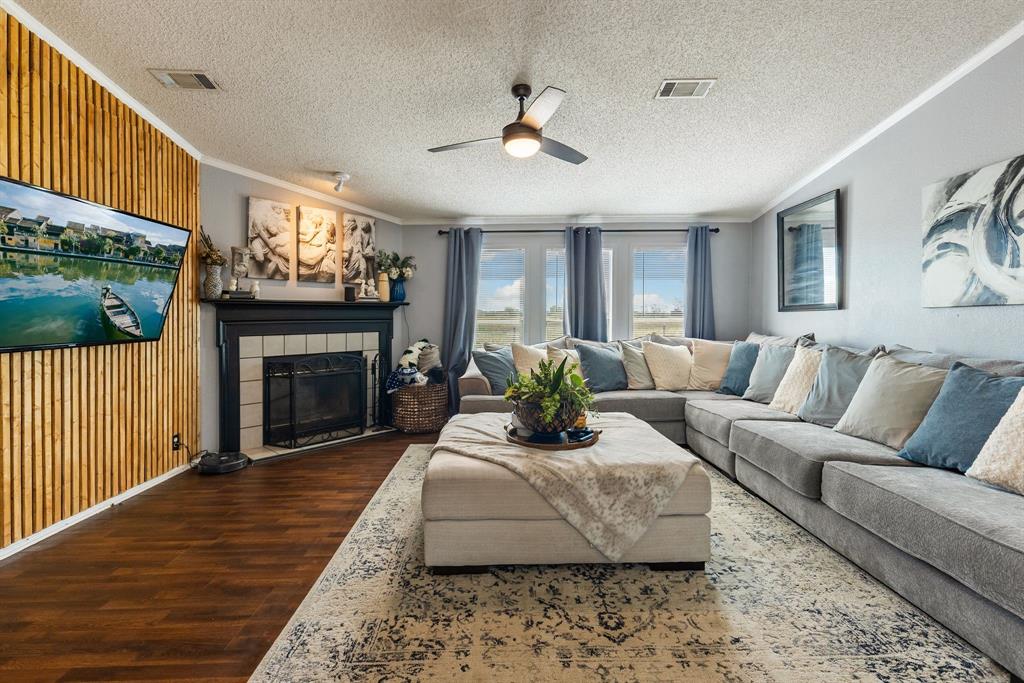 a living room with furniture a fireplace and a flat screen tv