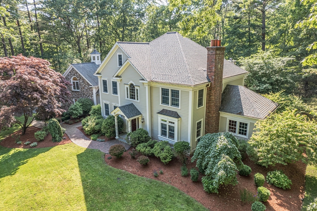 a aerial view of a house with yard and green space