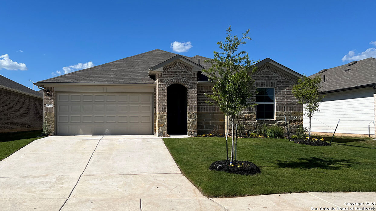 a front view of a house with a yard