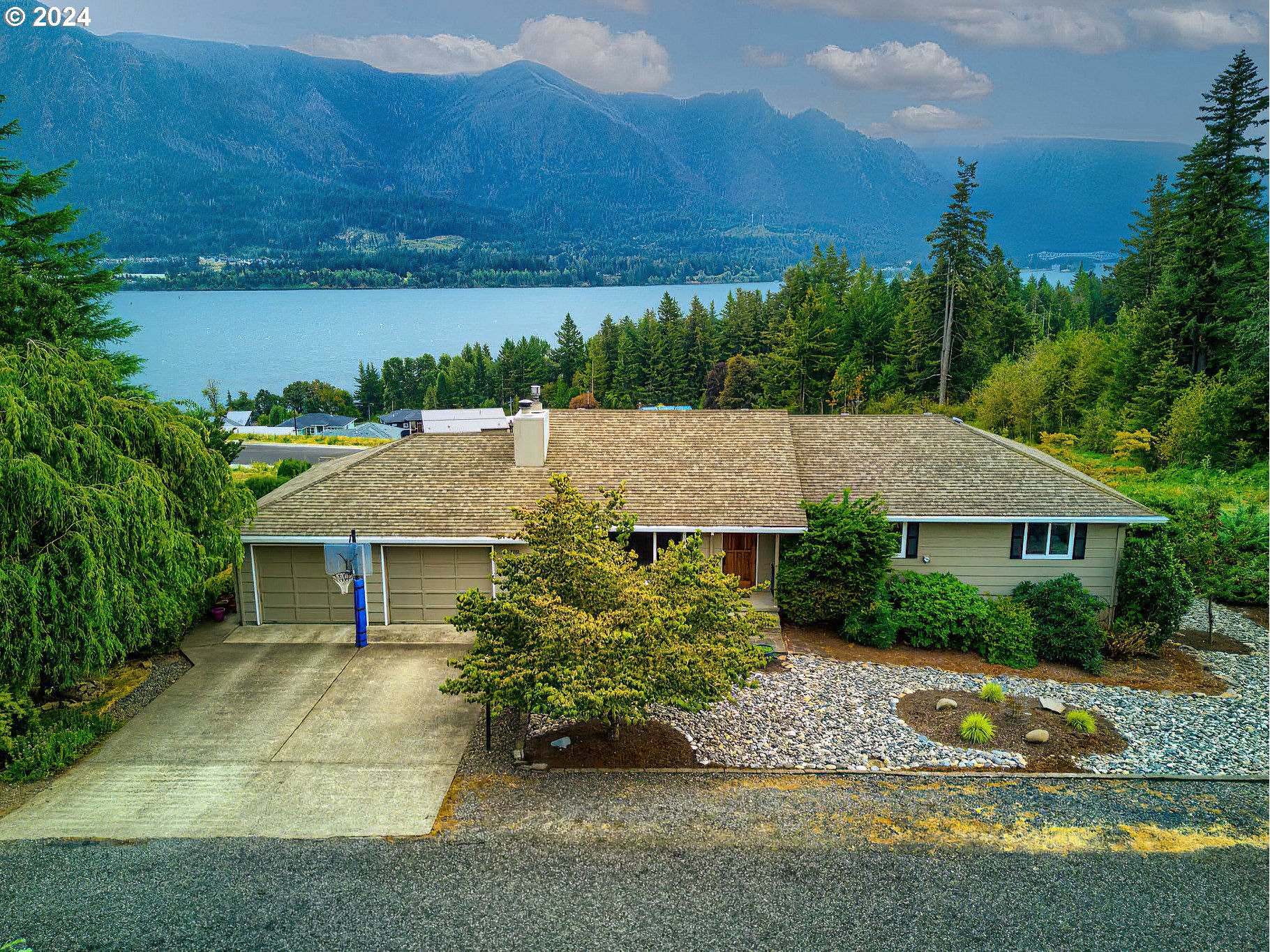 an aerial view of a house with a yard and lake view