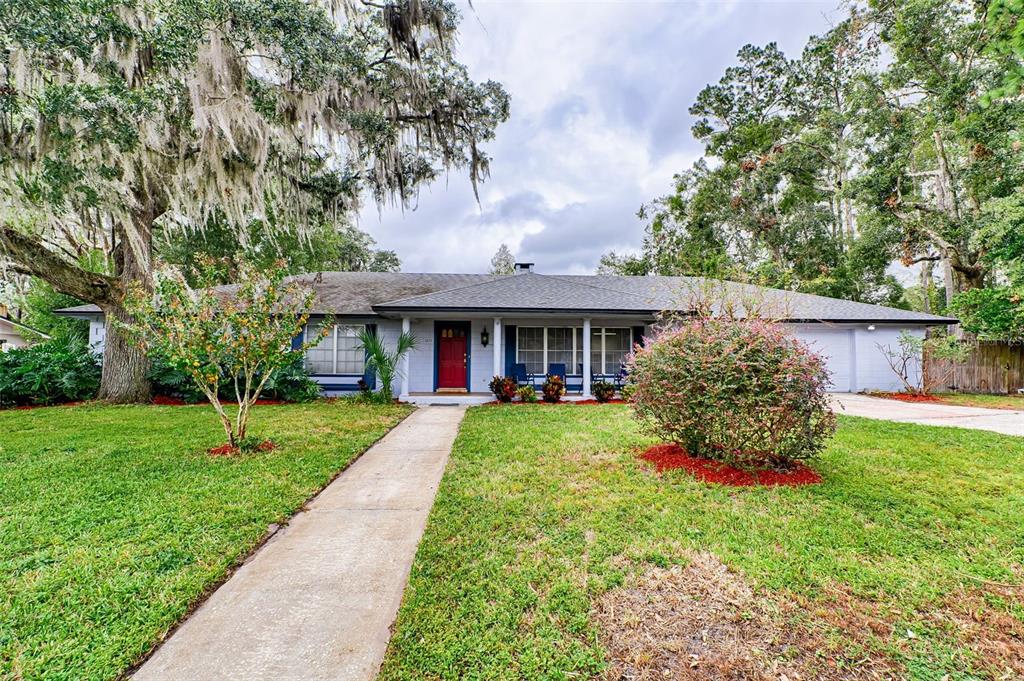 a front view of a house with a yard and porch