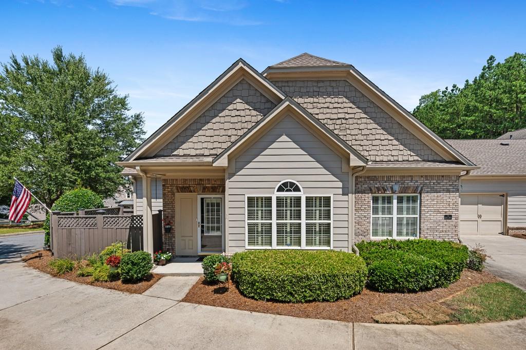 a front view of a house with a garden