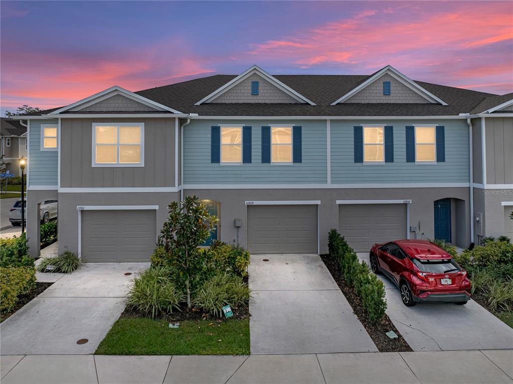 a front view of a house with a yard and garage