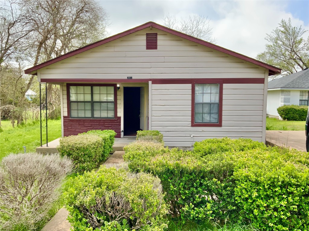 a front view of a house with garden