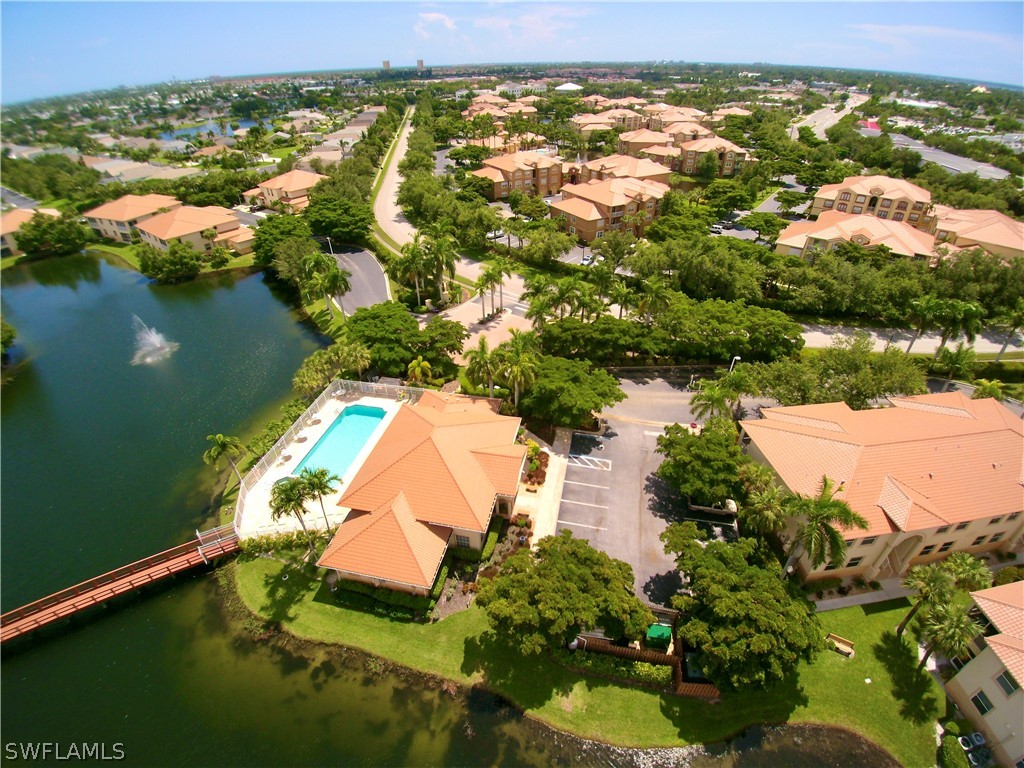 an aerial view of residential houses with outdoor space and lake view