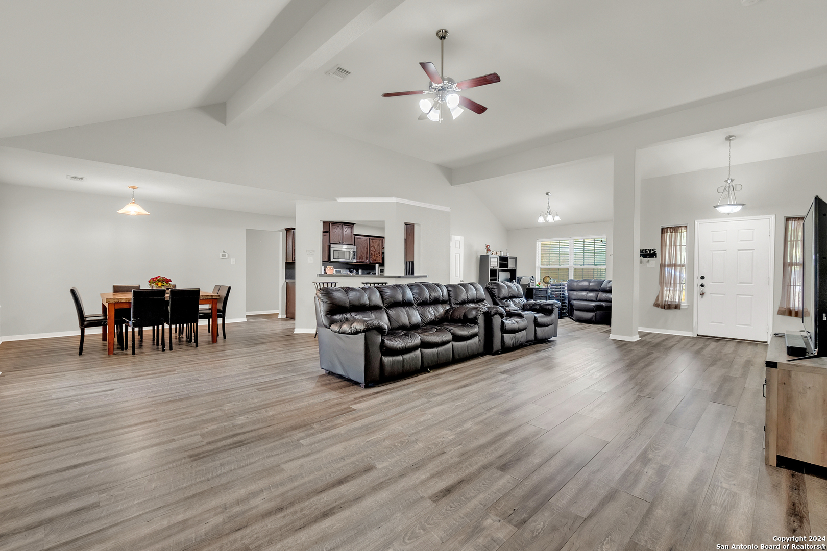 a living room with furniture and wooden floor