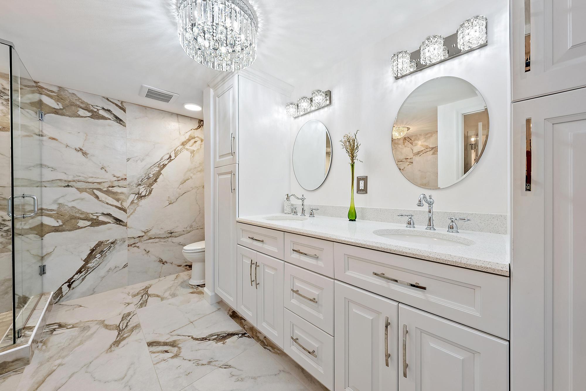 a bathroom with a double vanity sink mirror and shower