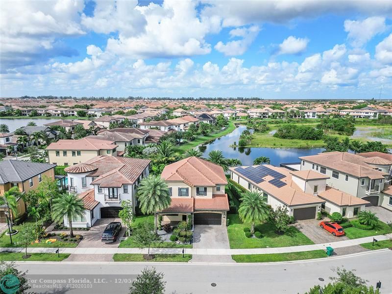 an aerial view of multiple houses with yard