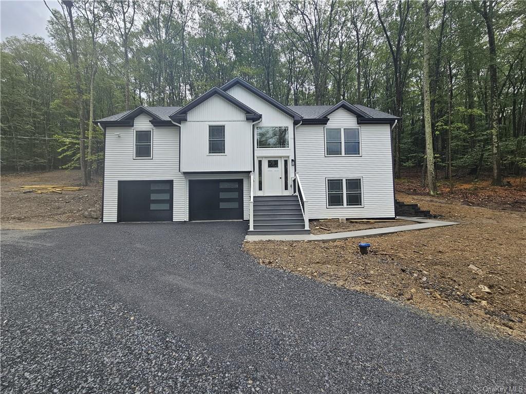 a view of a house with a yard and garage