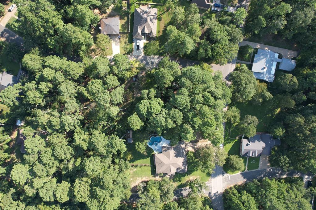 an aerial view of a house with a yard and outdoor seating