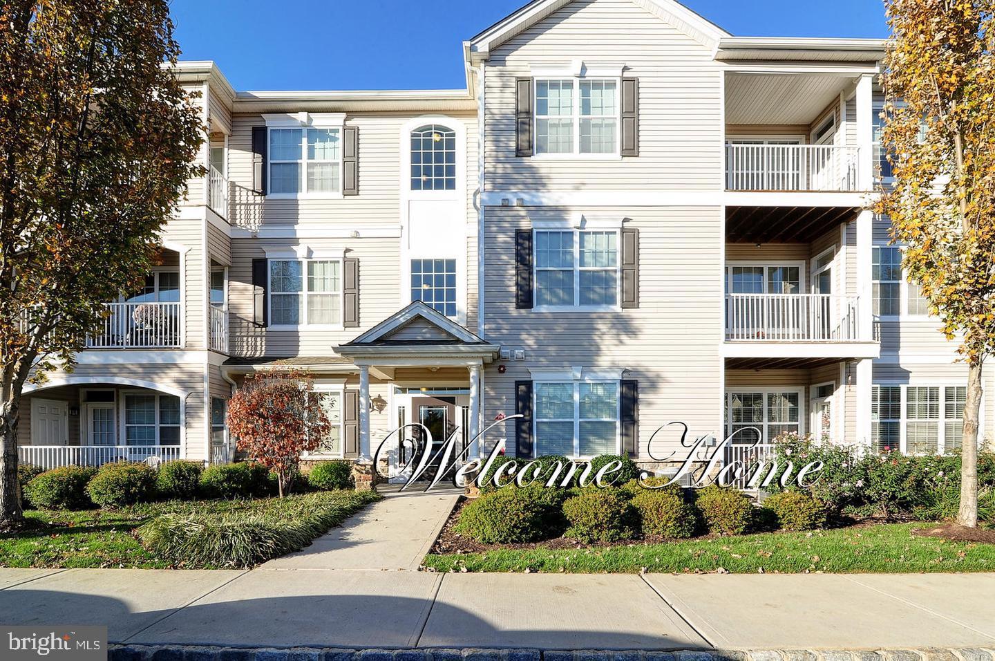 a front view of a residential apartment building with a yard