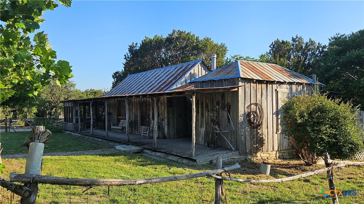 a view of a house with yard and sitting area