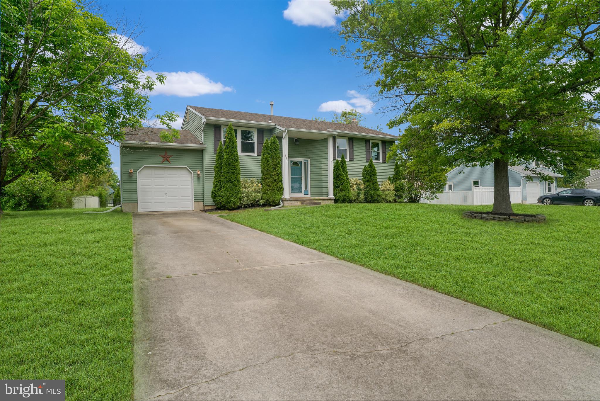 a front view of a house with a yard and potted plants