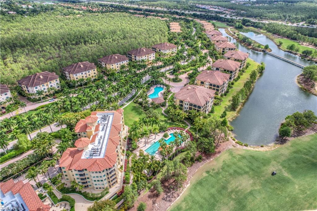 an aerial view of a house with a yard and lake view