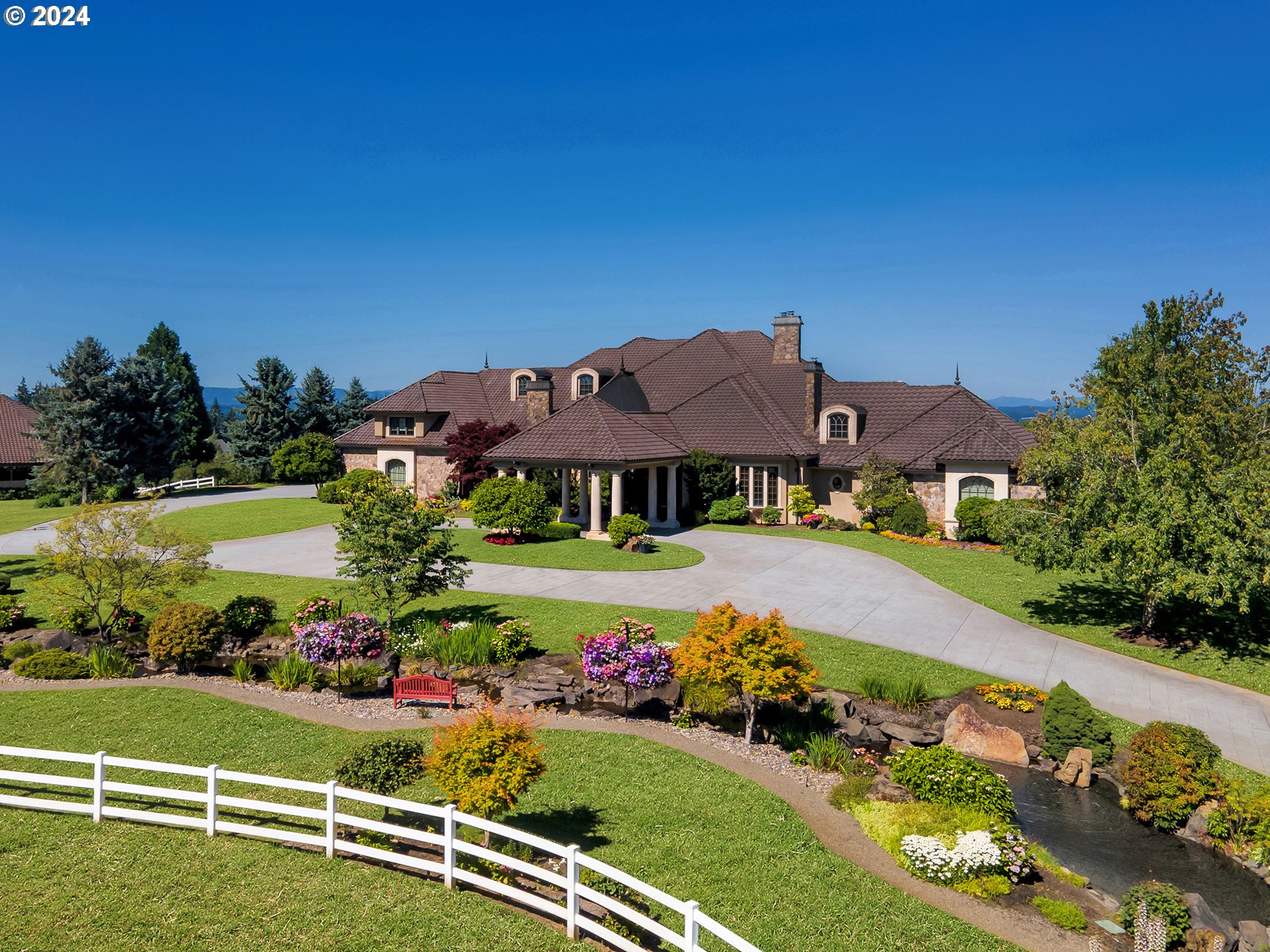 a view of a house with a big yard and potted plants