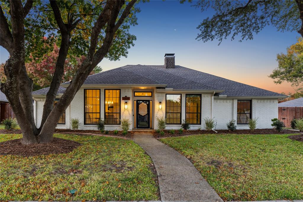 Two specimen live oak trees shade the front walkway. Fantastic symmetrical architecture.