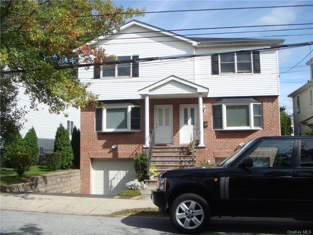 a front view of a house with parking space